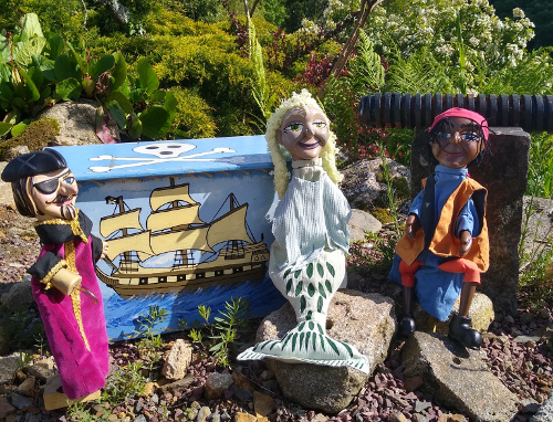 Pirate Puppets sitting next to a pirate's treasure chest